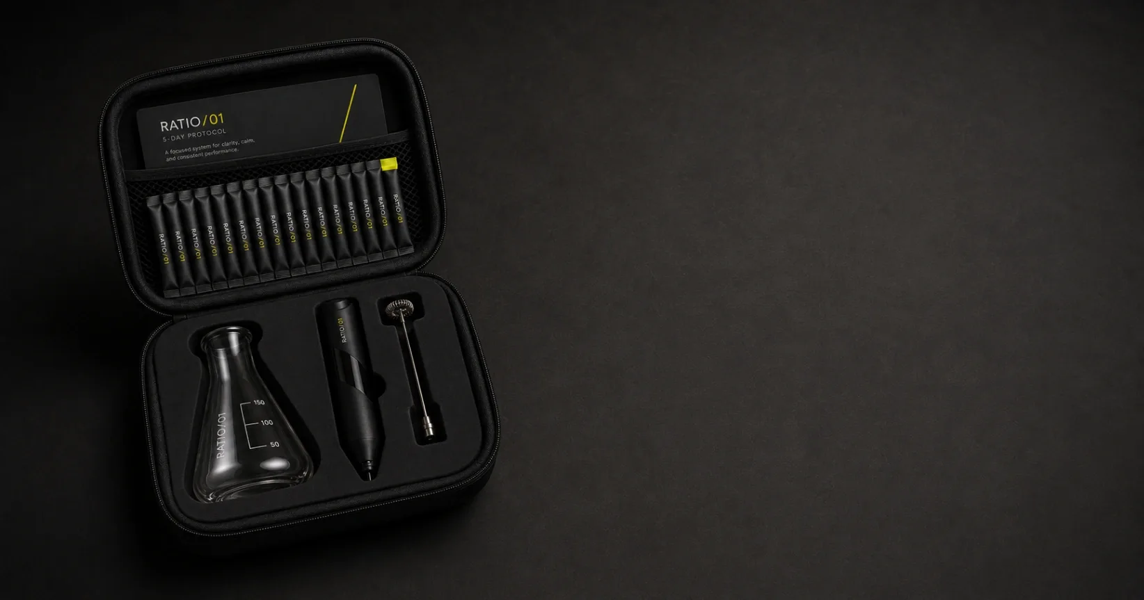 The Protocol Kit open on graphite: a row of RATIO/01 sachets and the 5-Day Protocol card in the lid, lab glass and assembled mixer in the cut foam