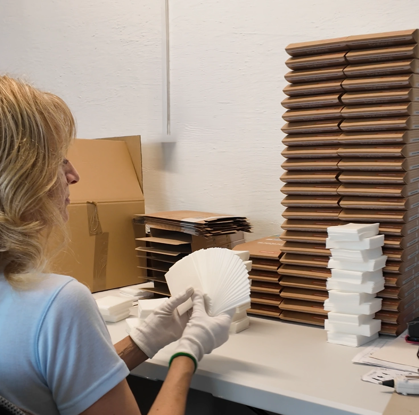 Briters laundry sheet packs being filled by hand
